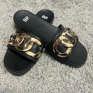 Black sandals with gold accent